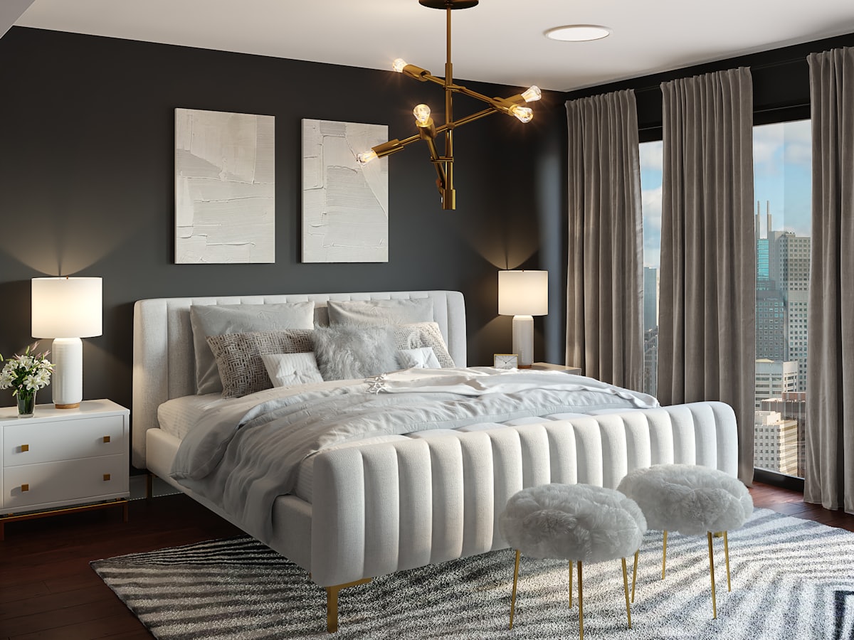 Bedroom with a made bed, side tables, and space to walk to the wardrobe